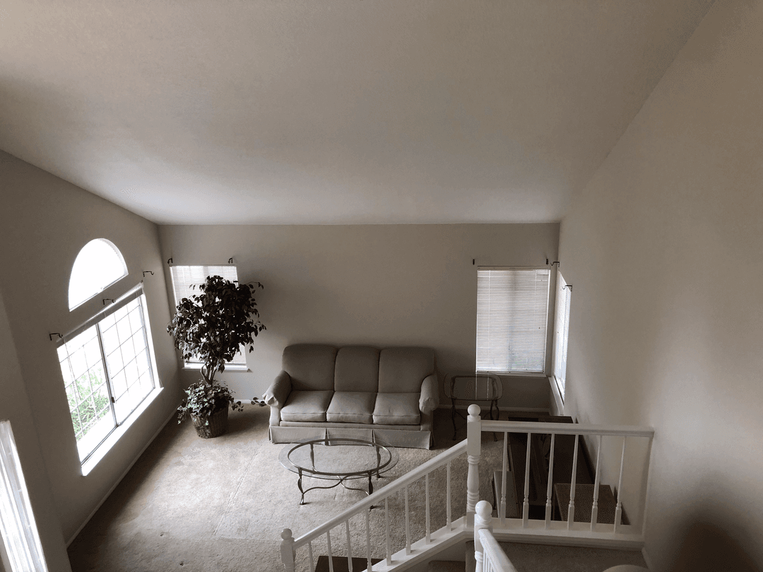 Upstairs living area with newly painted walls and staircase