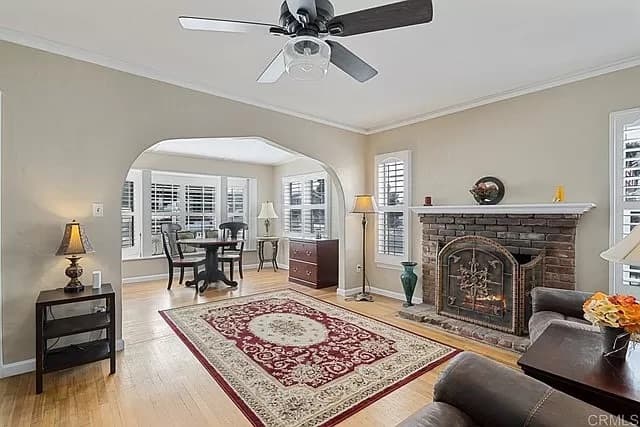 Living room interior painting with brick fireplace and hardwood floors in San Diego home